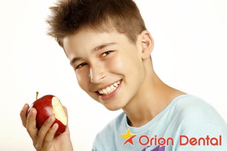 Stock image of a boy eating an apple