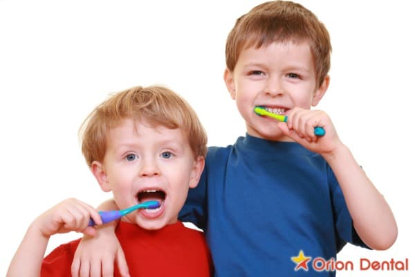 Stock image of a young child brushing their teeth