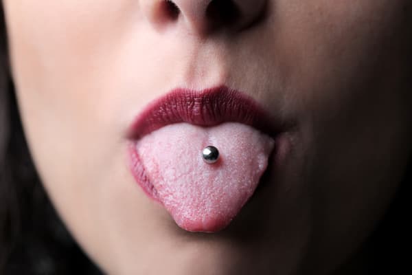 Stock image of a close-up of a tongue piercing