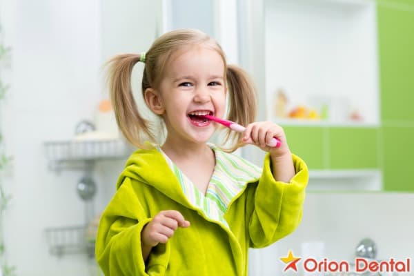 Stock image of a child brushing their teeth in a bathroom