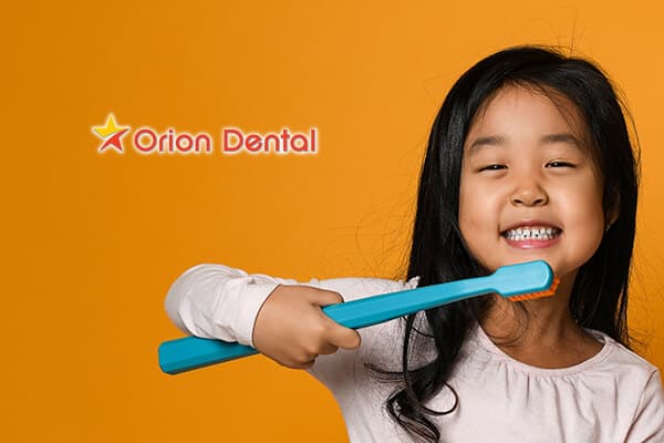 Stock image of a young girl brushing her teeth