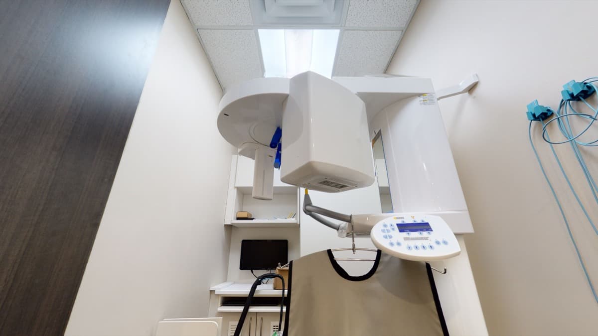 The panoramic X-ray unit and lead apron in the imaging room at Orion Dental Scarborough