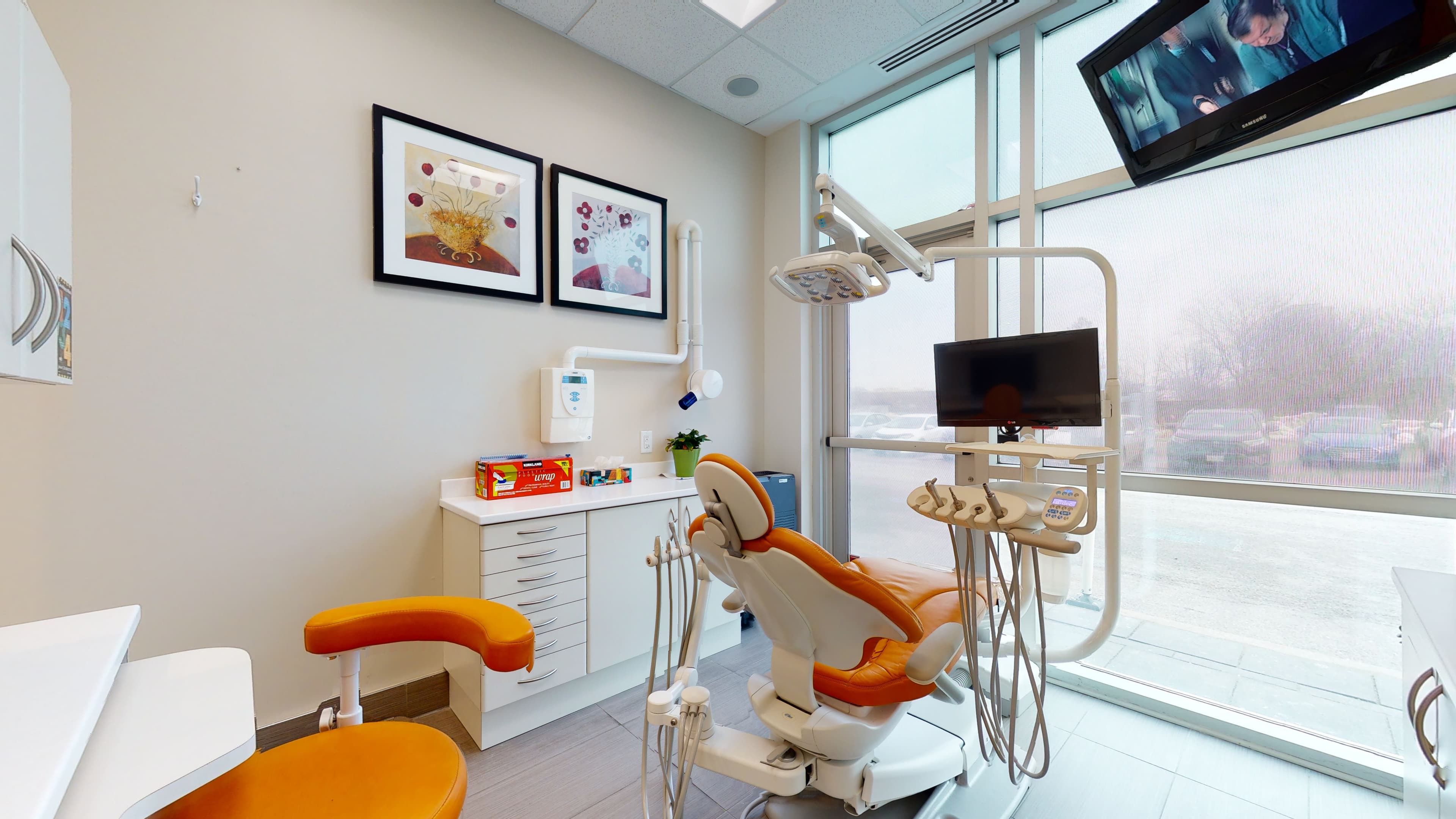 A treatment room at Orion Dental Scarborough, with an orange dental chair beside a floor-to-ceiling window