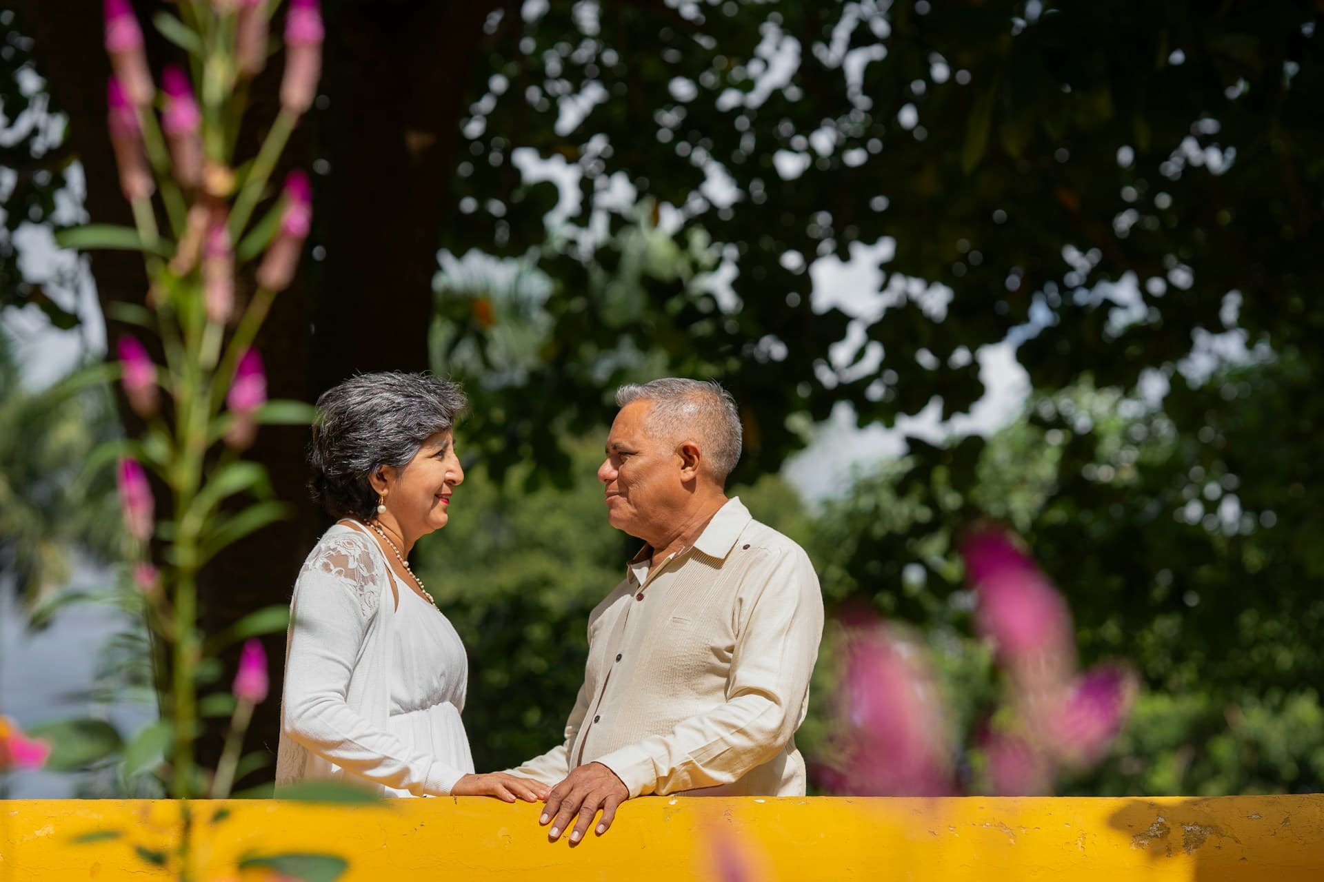 Stock image of a senior couple smiling at each other outdoors